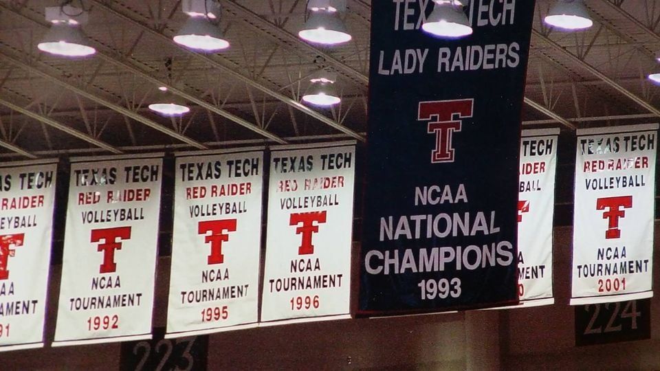 Banners hanging from a ceiling, reading 