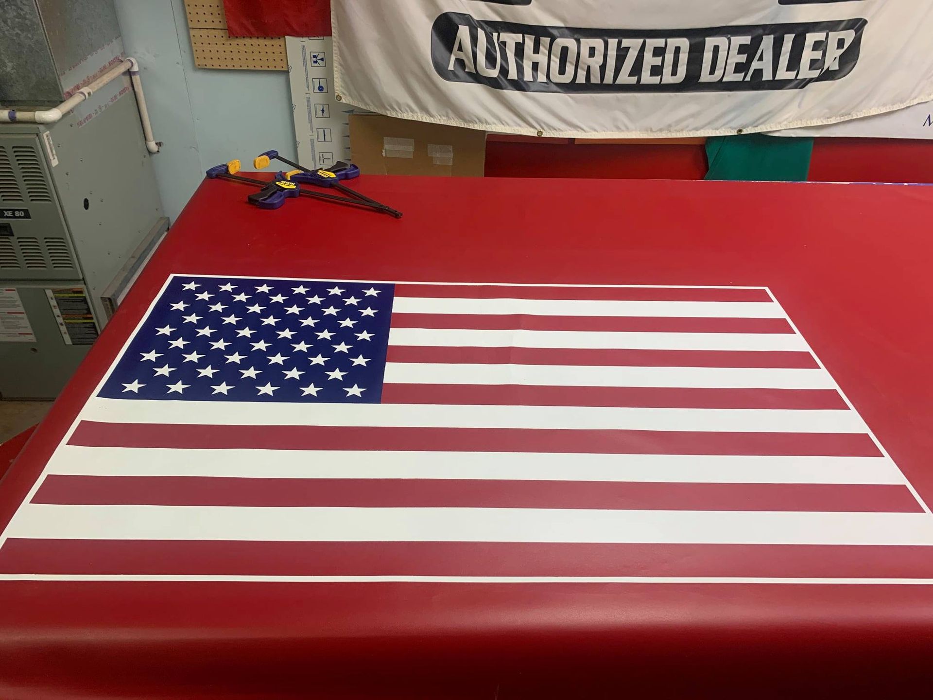 American flag laid out on a red surface, with a banner that says 