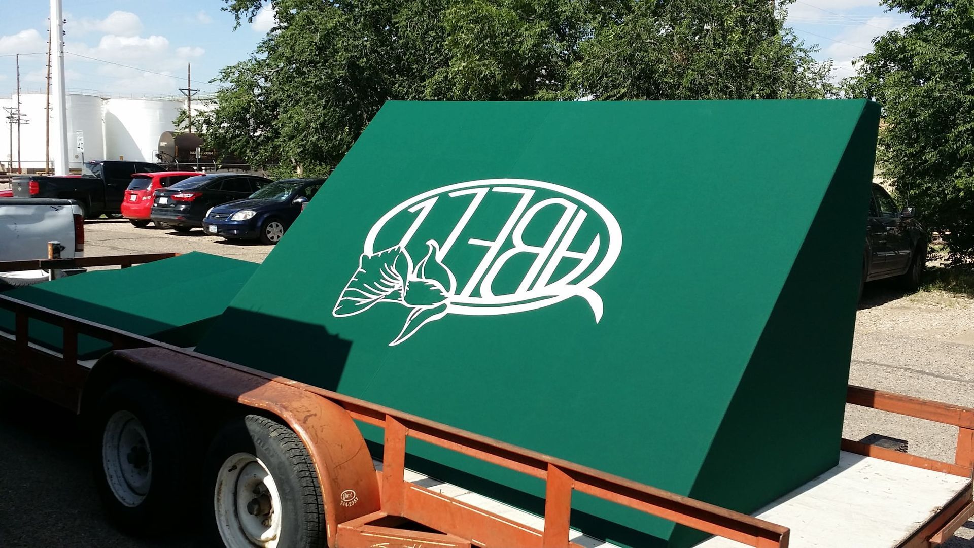 Green trailer with white logo that reads 