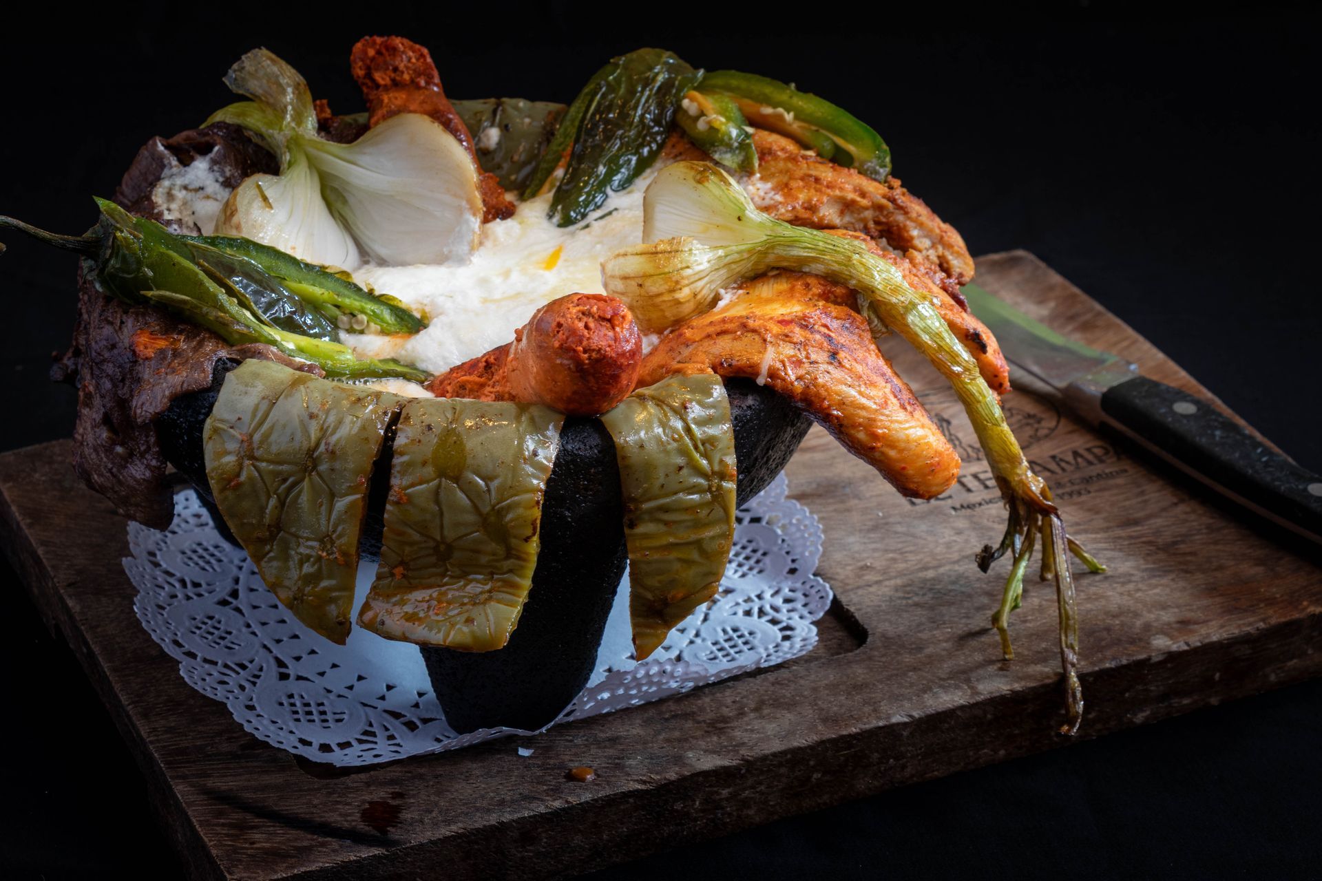 Mexican food platter with avocado slices, rice, sour cream, and shredded lettuce