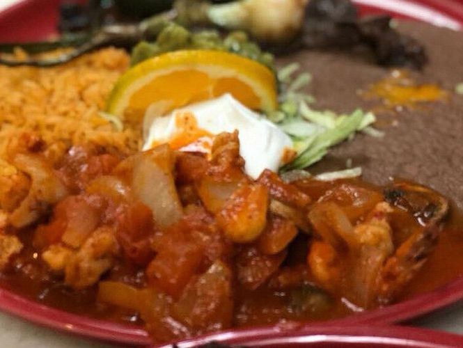 Mexican platter with shrimp, chorizo, peppers, and grilled vegetables