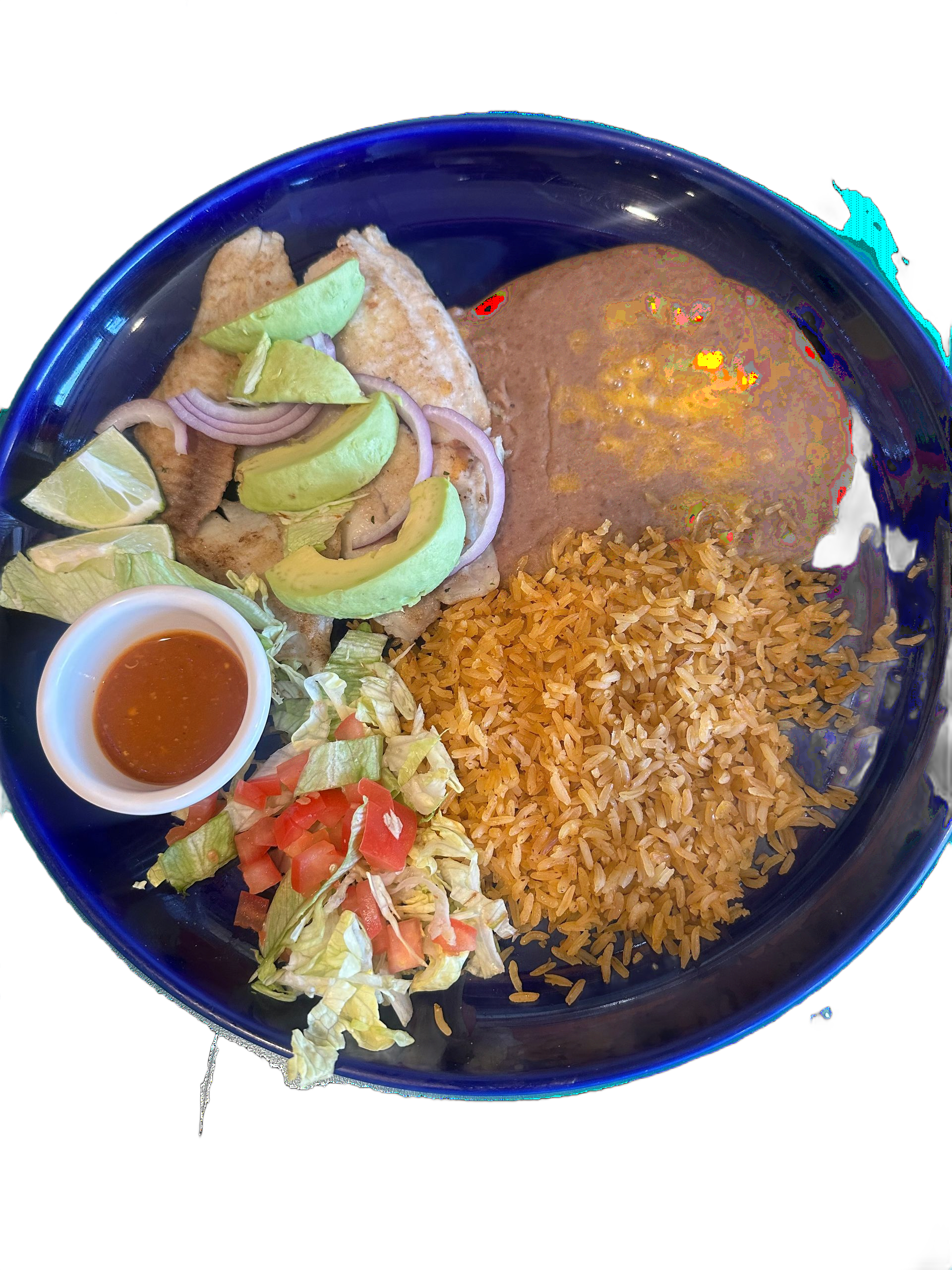 Garlic butter shrimp in a white bowl with lime wedge