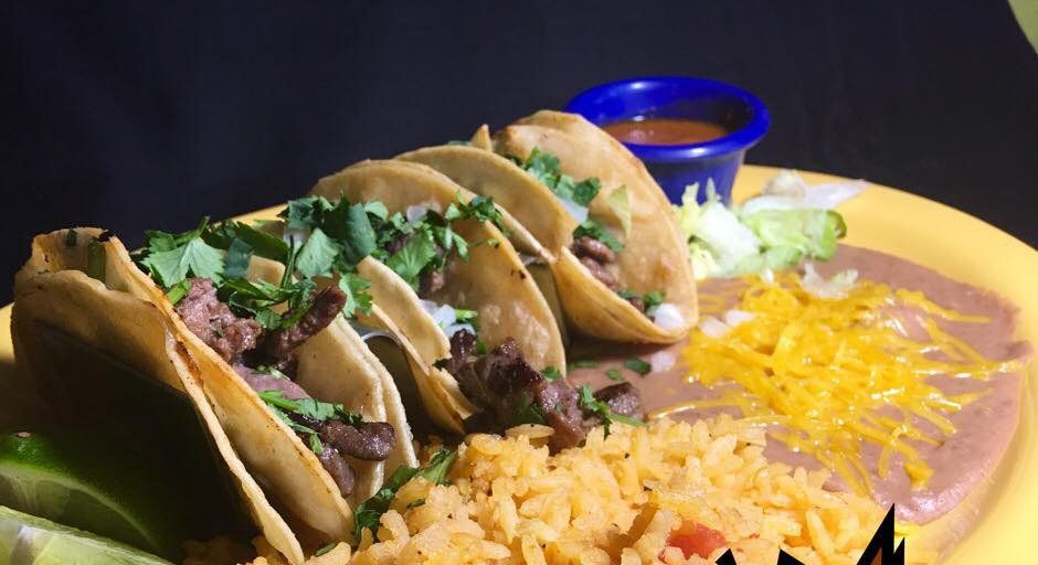 Hands holding a molcajete filled with fresh guacamole