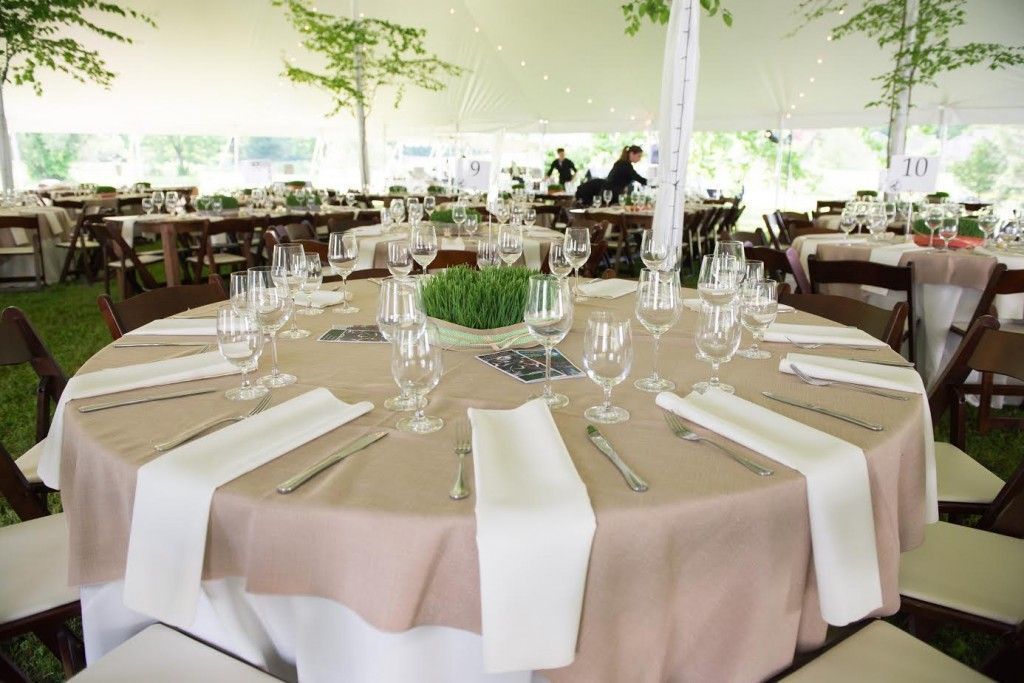 Wedding reception tent with round table set for guests.