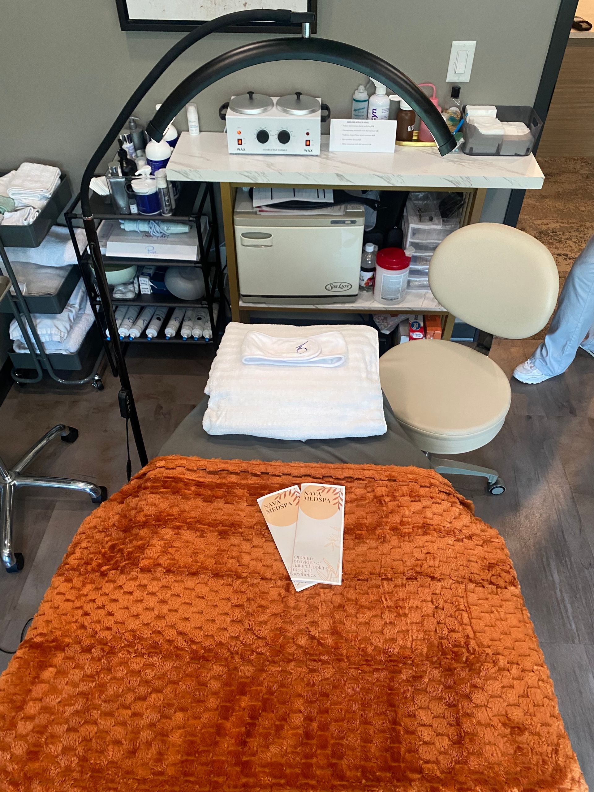 Treatment table with equipment and supplies, and a small stack of papers.