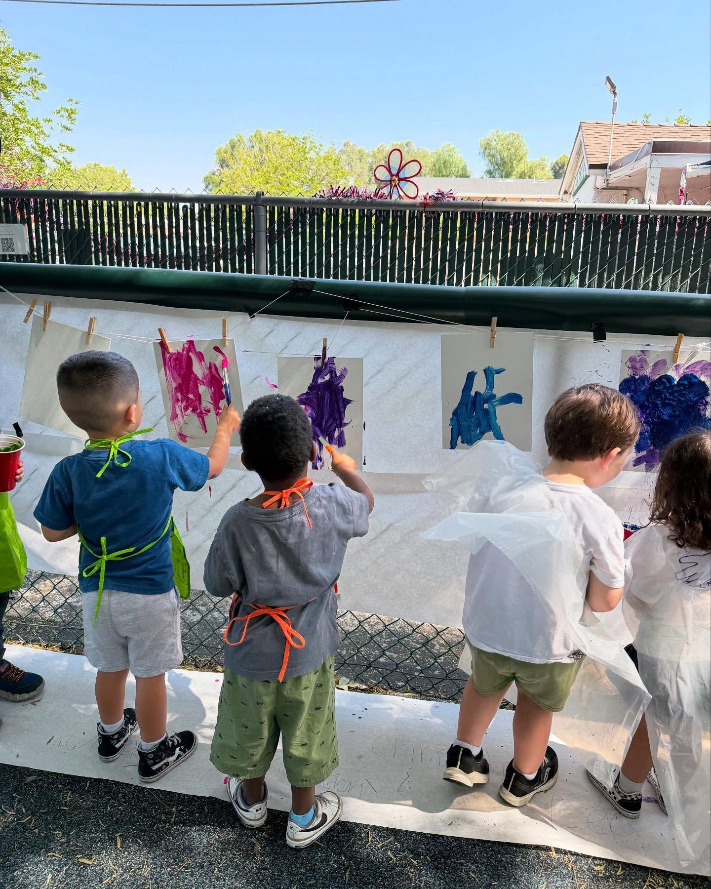 Two children seated at a table playing with toys in a classroom.