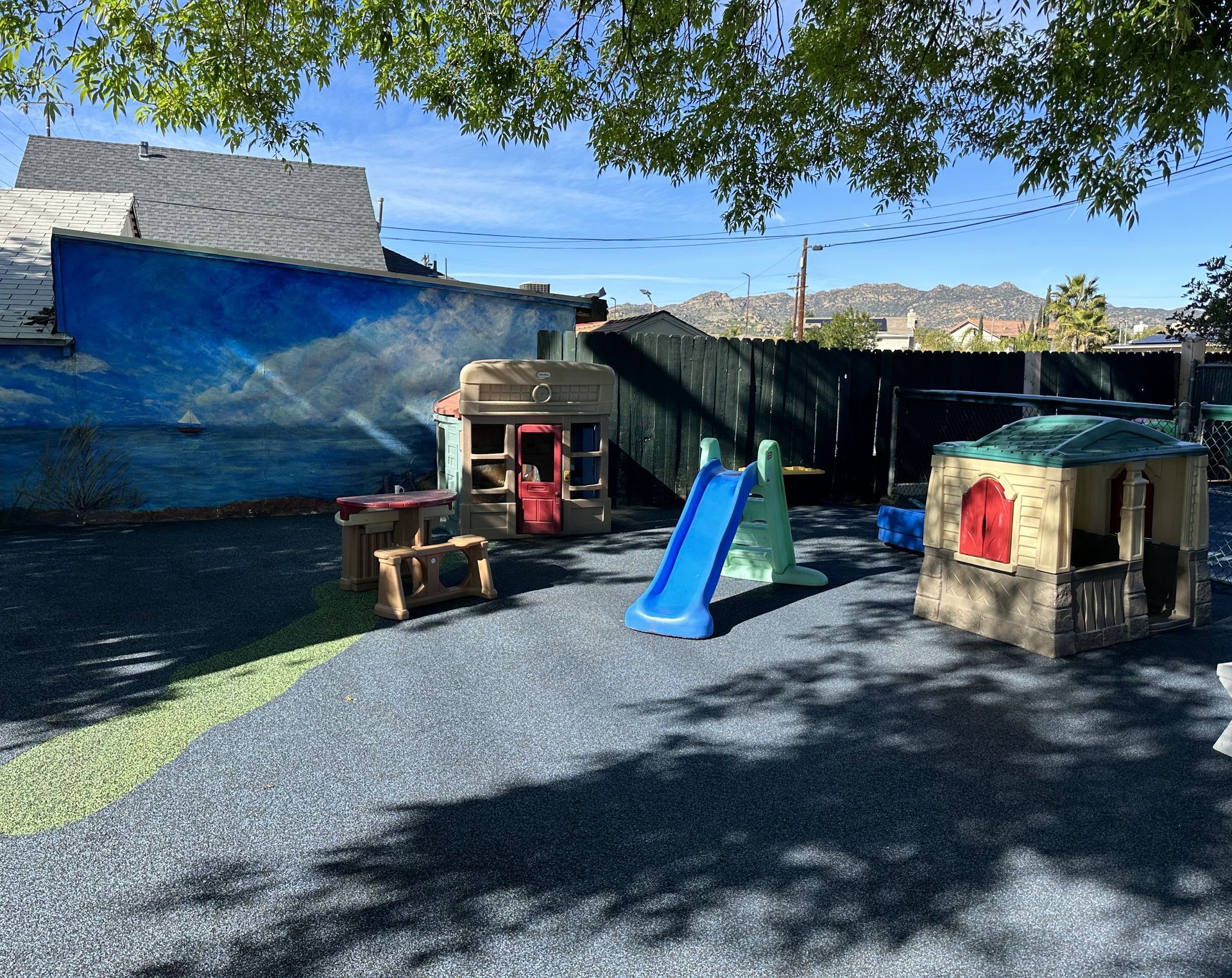 Children at a table playing with colorful blocks in a classroom.