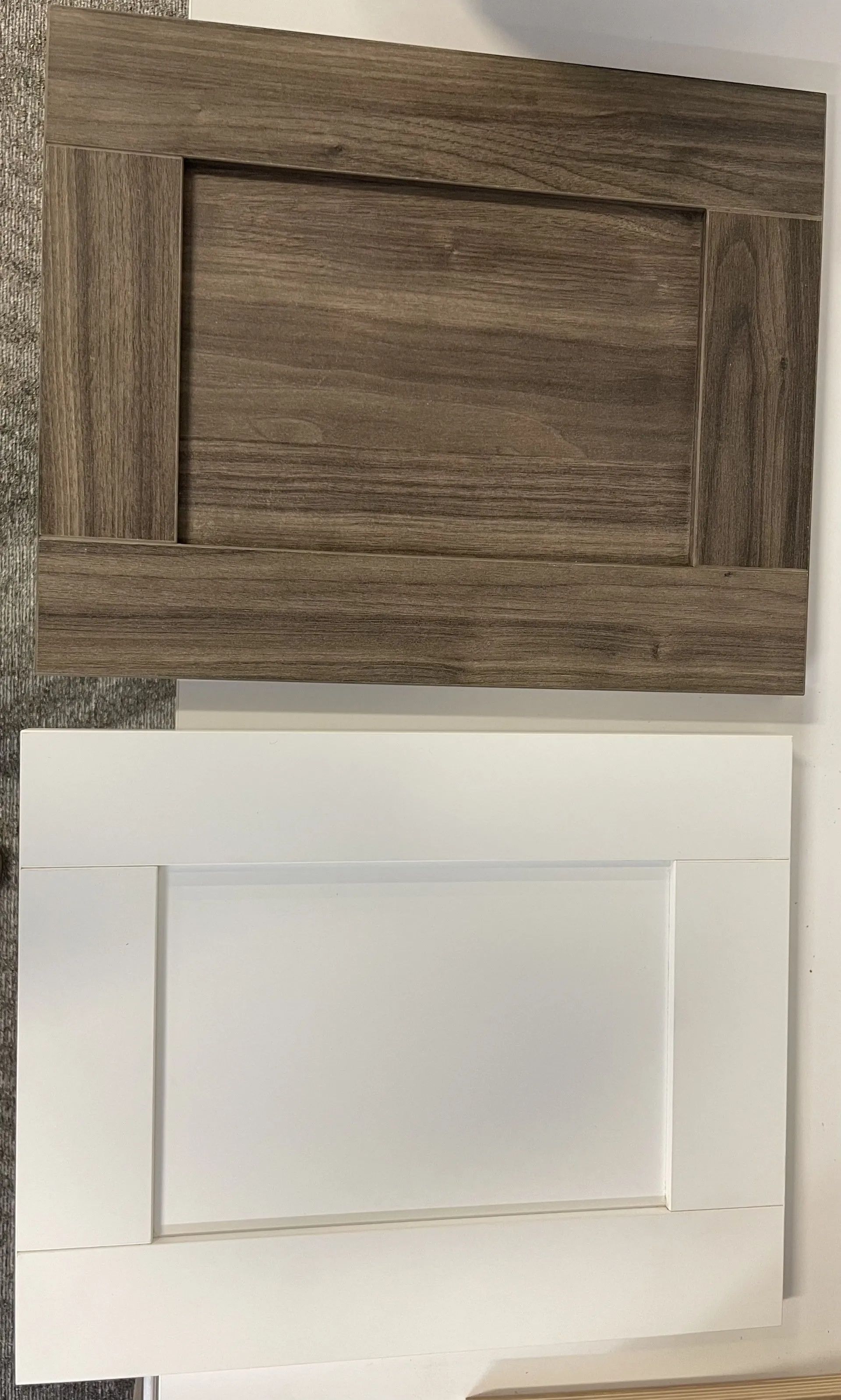 Two cabinet door samples: one wood-grain brown and one white.