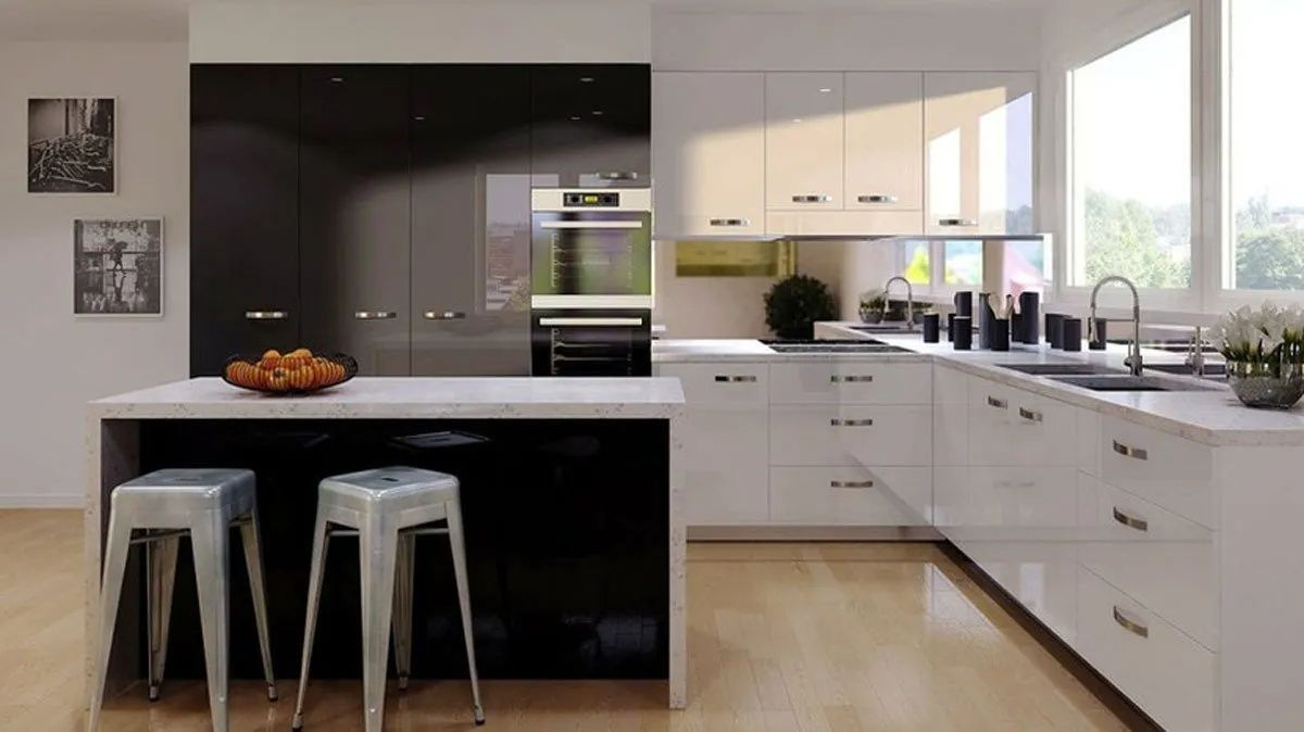 Modern kitchen with white and black cabinets, island with stools, and large windows.