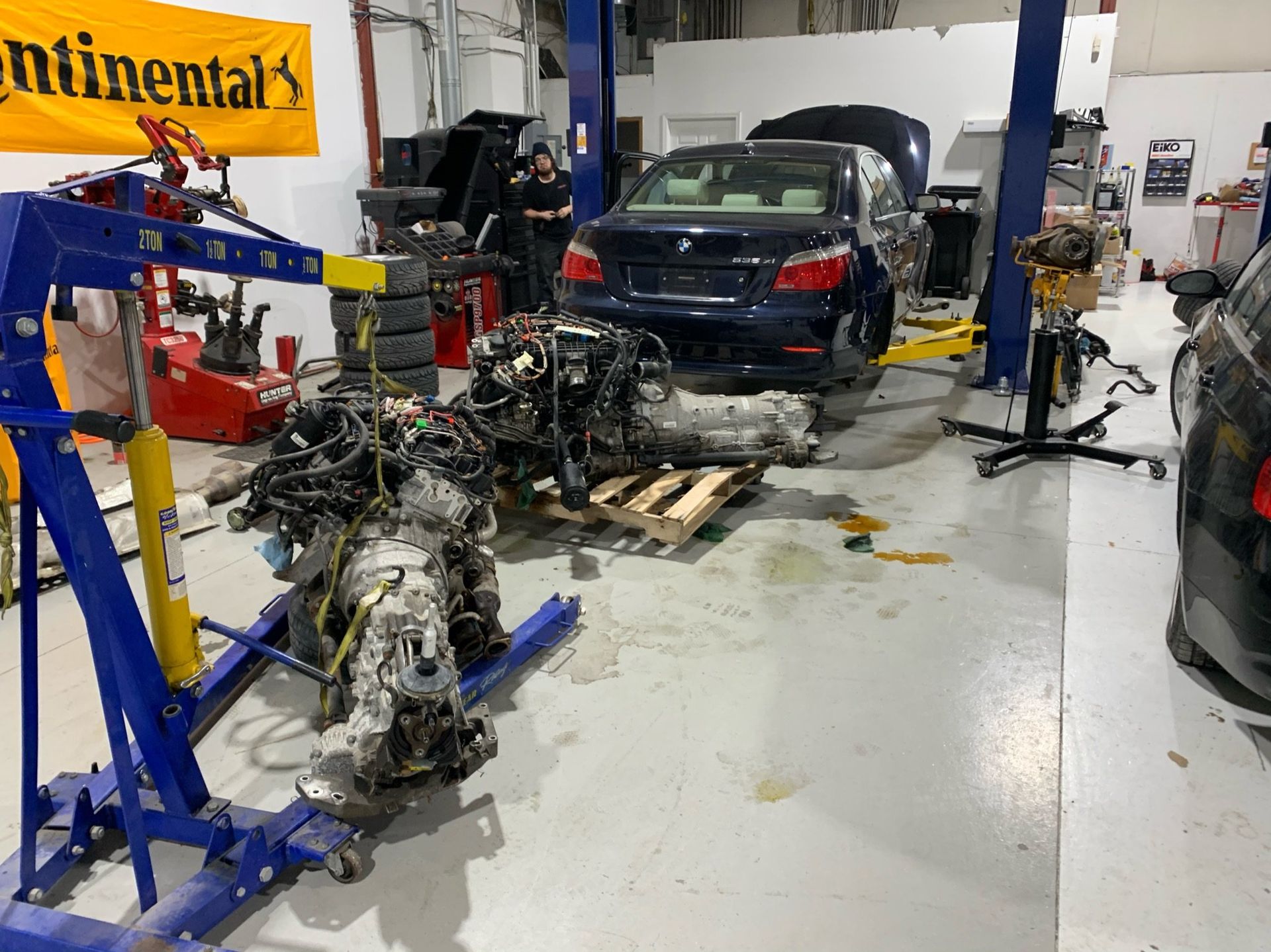 a car engine is being worked on in a garage 