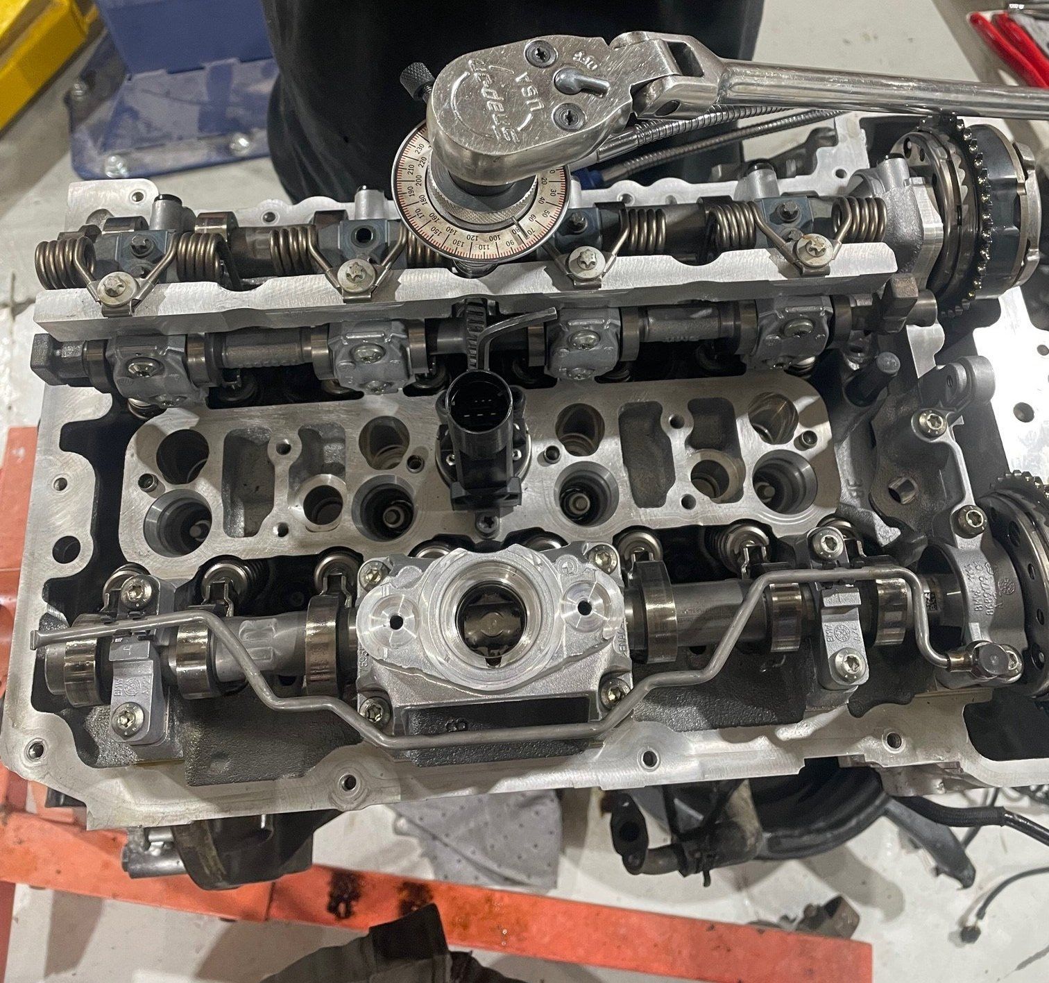 a close up of a car engine with a wrench on top of it