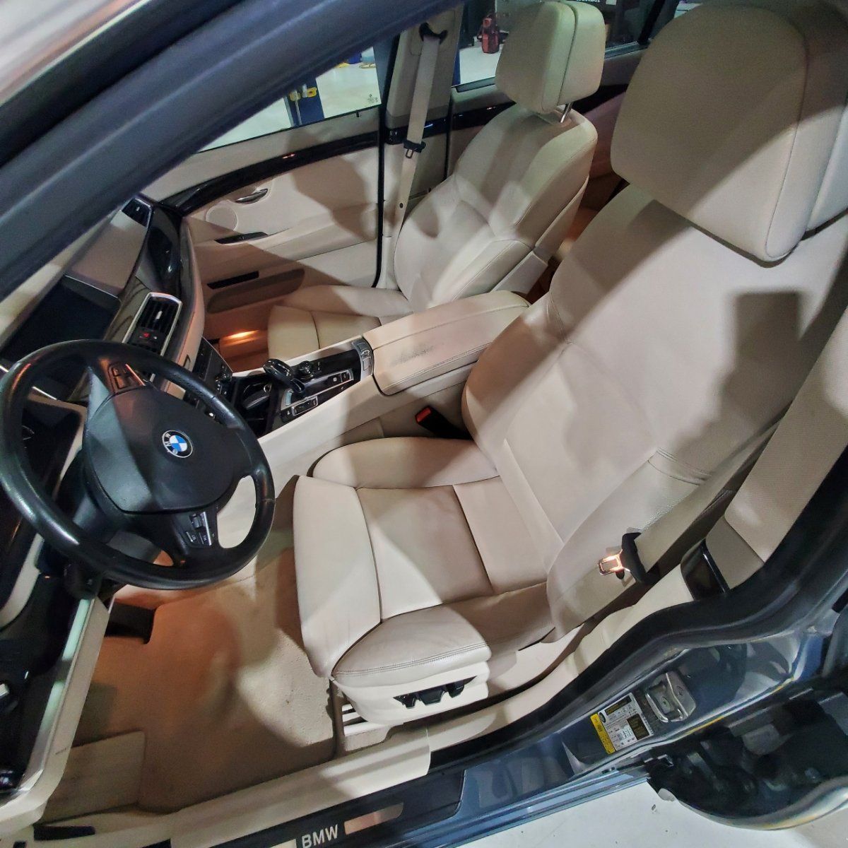 the inside of a bmw car with the door open