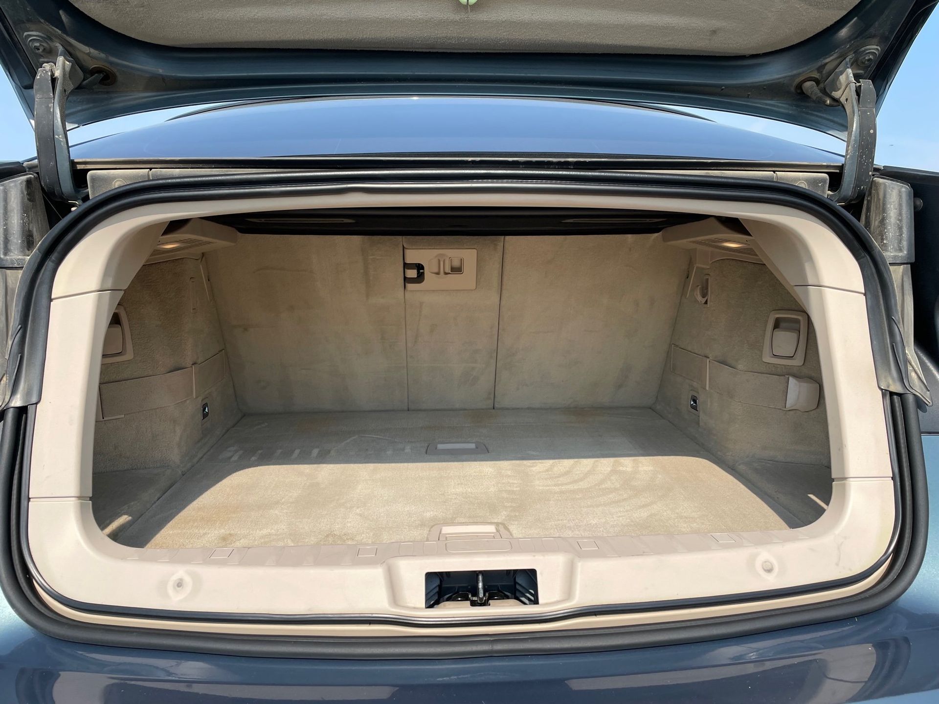 the trunk of a car is open and empty