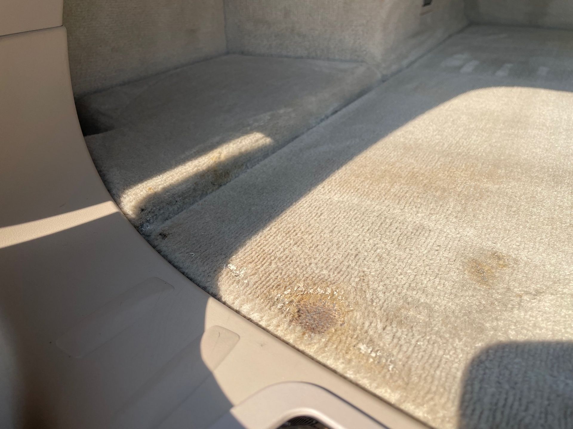 a close up of a car trunk with a shadow on it