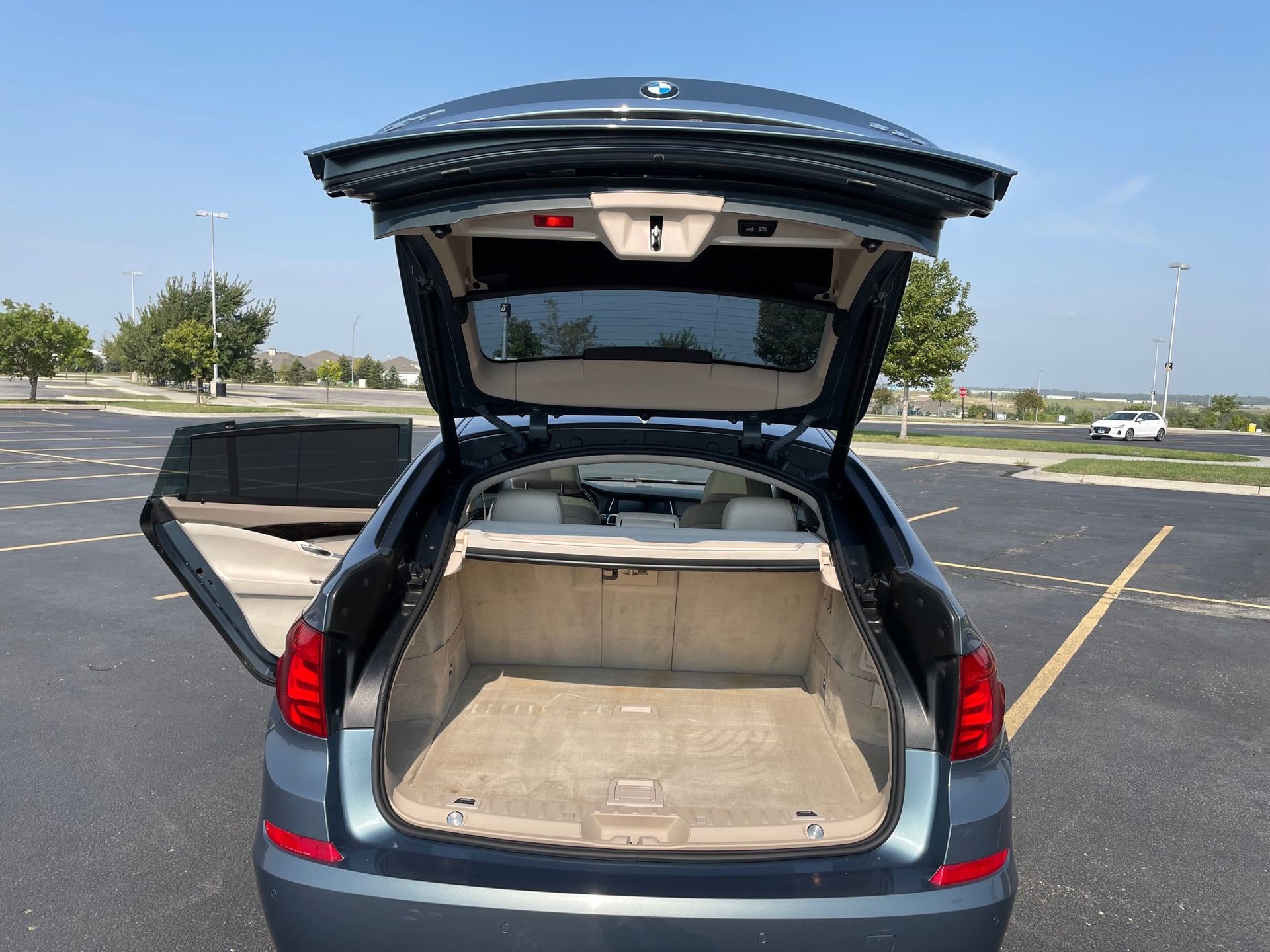 the trunk of a car is open in a parking lot