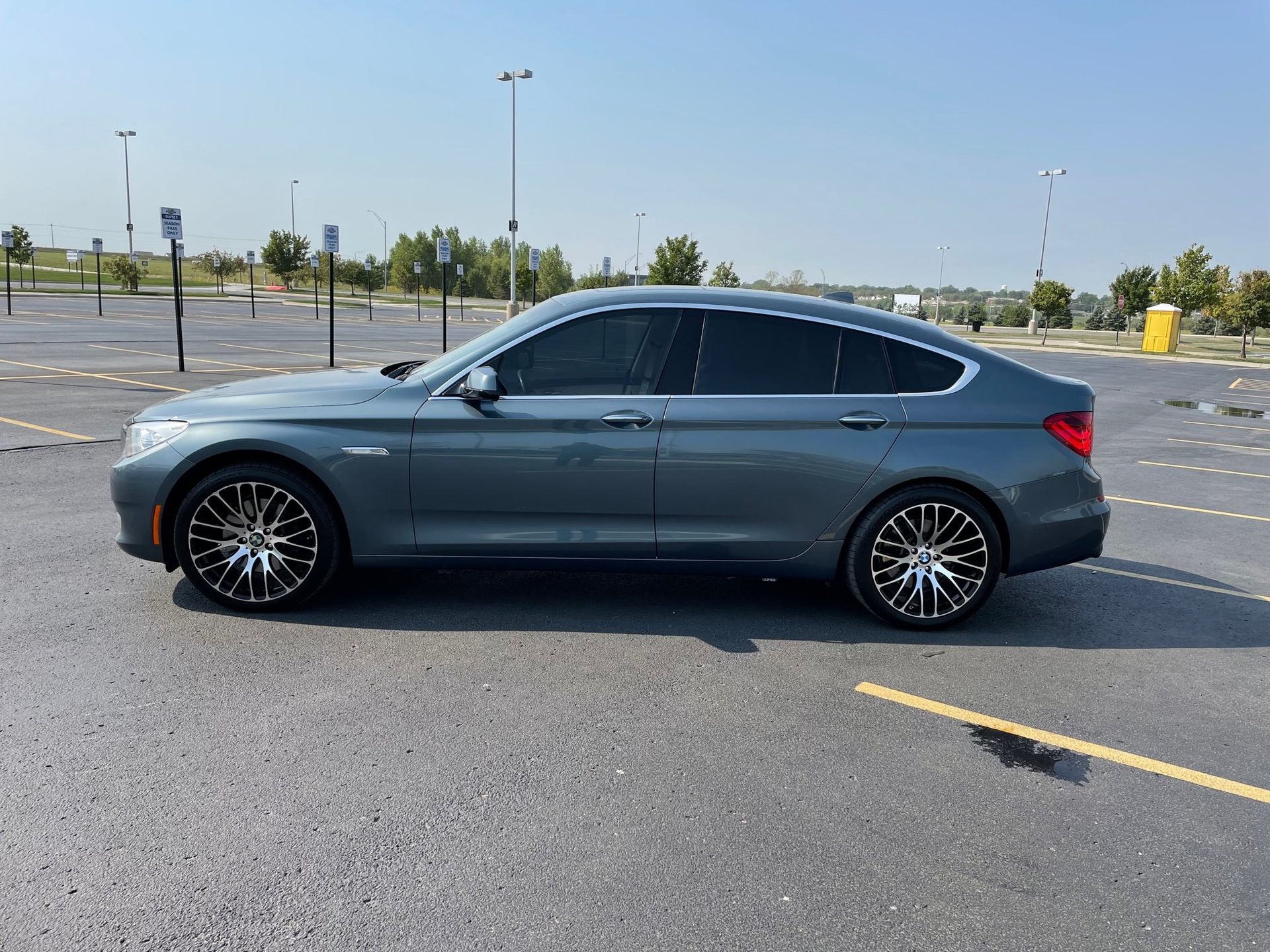 a bmw is parked in a parking lot on a sunny day