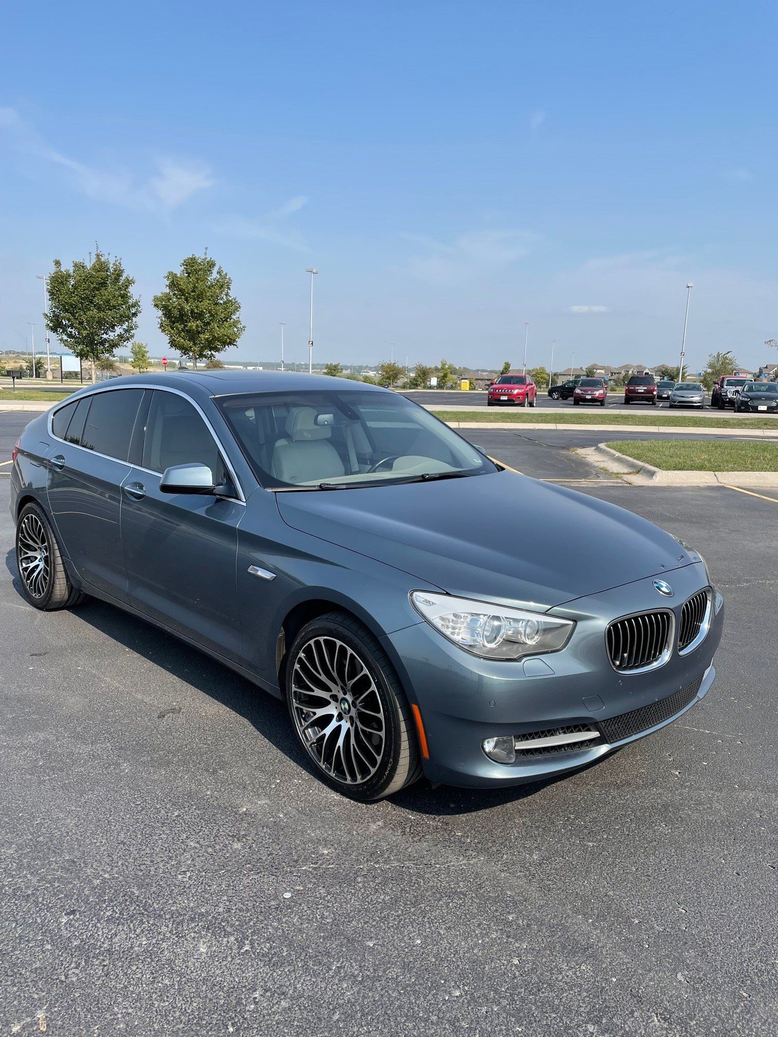 a bmw 5 series is parked in a parking lot