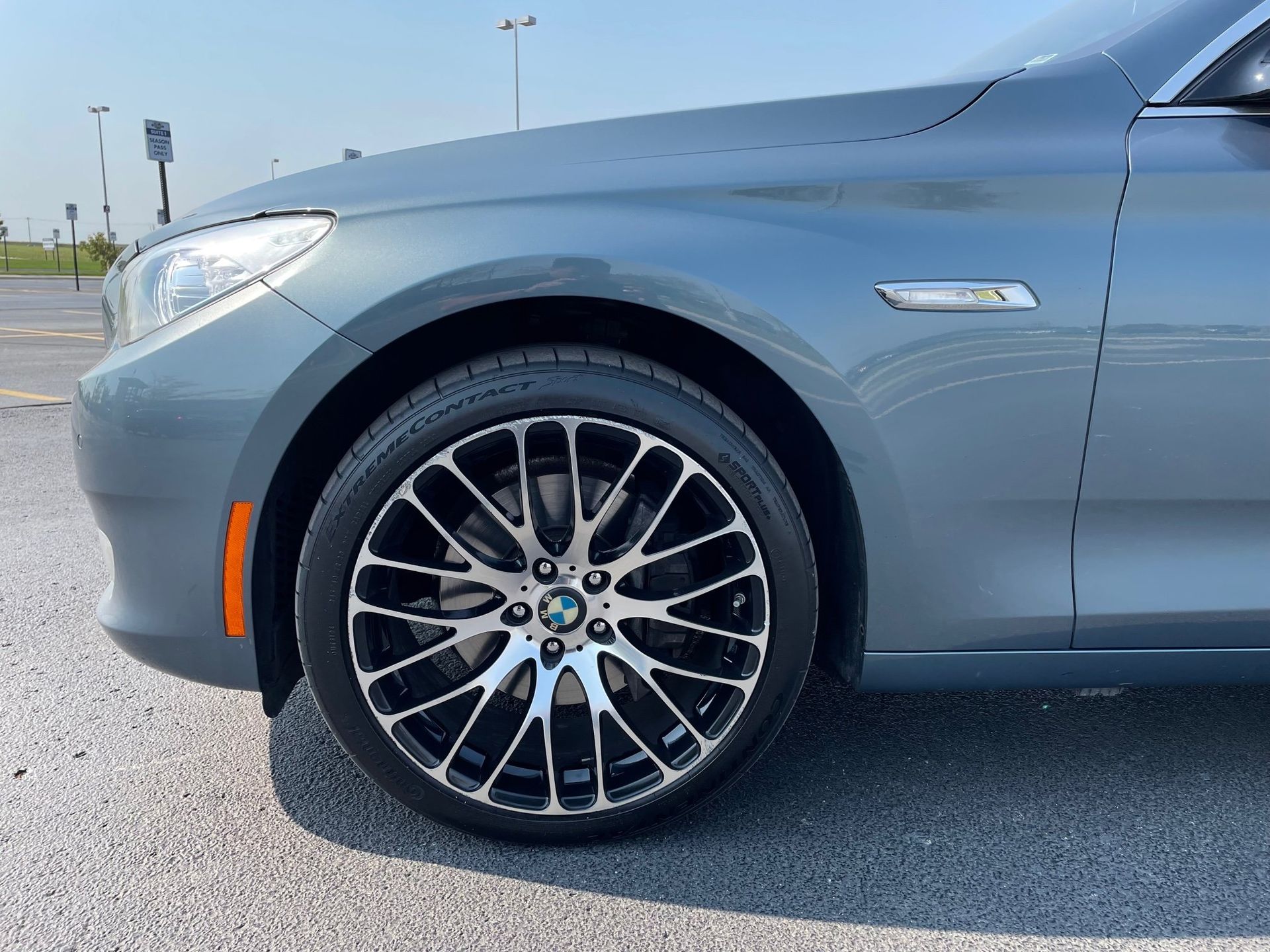 a bmw is parked in a parking lot on a sunny day