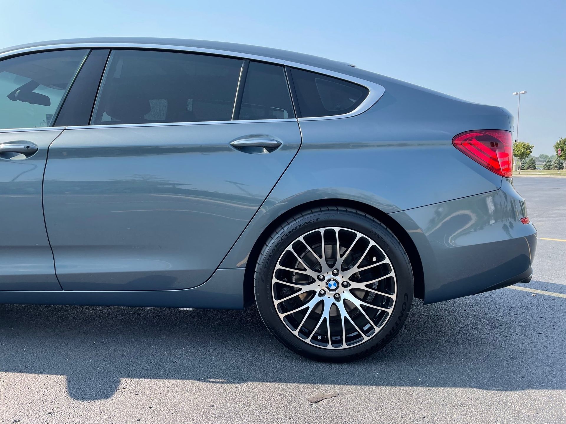 a bmw 5 series is parked in a parking lot