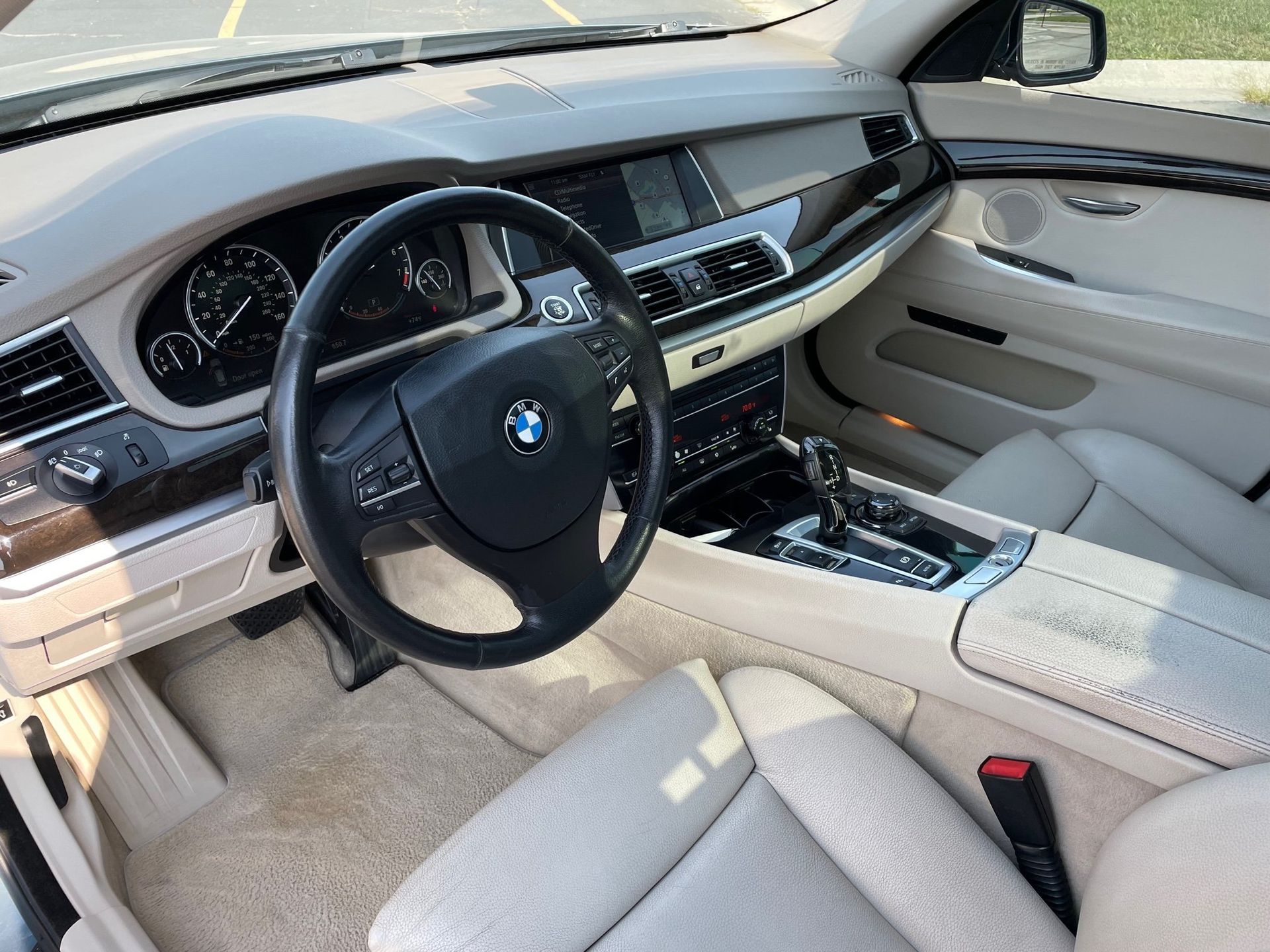 the interior of a bmw with a steering wheel and dashboard