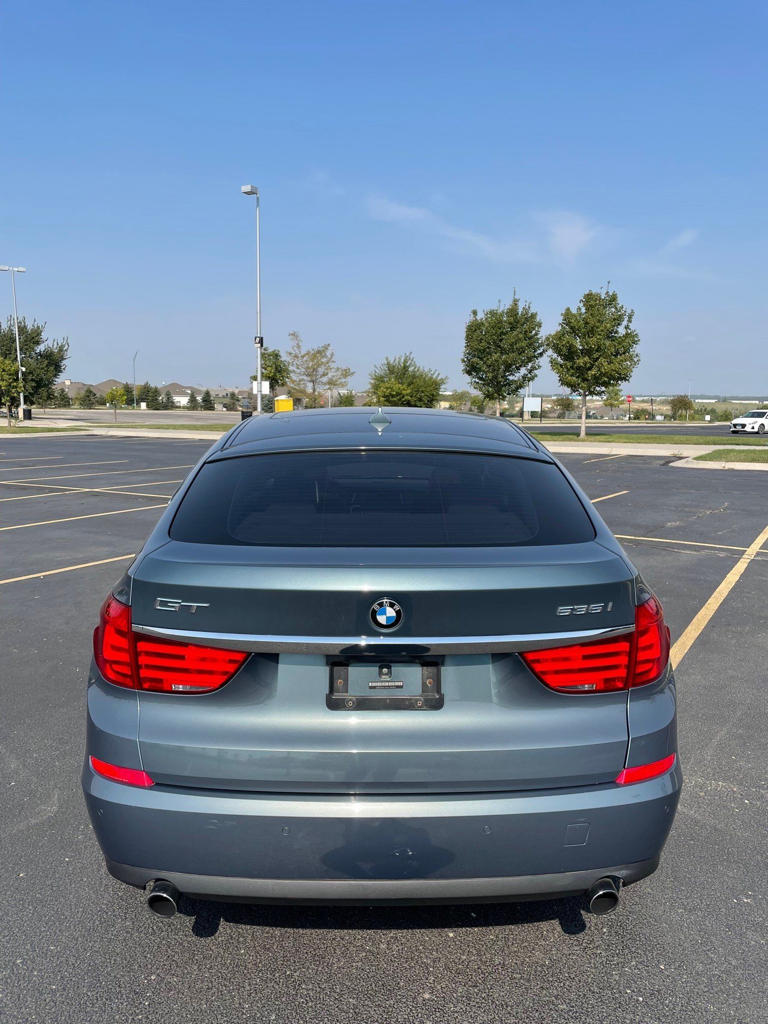 a bmw is parked in a parking lot on a sunny day