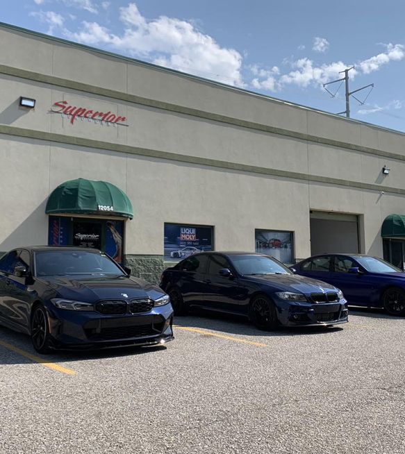 three cars are parked in front of a building that says superior