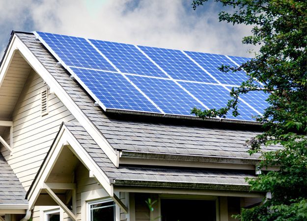Solar panels installed on a residential house rooftop, generating clean energy.