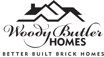 The logo for woody butler homes better built brick homes