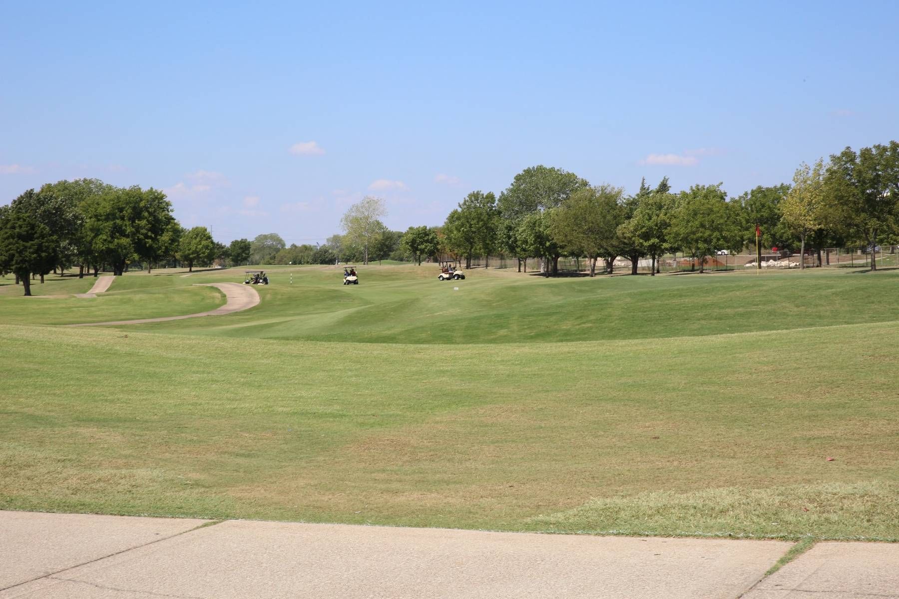 A golf course with a lot of grass and trees