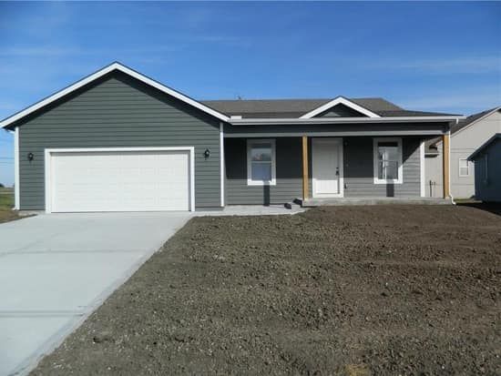 A gray house with a white garage door