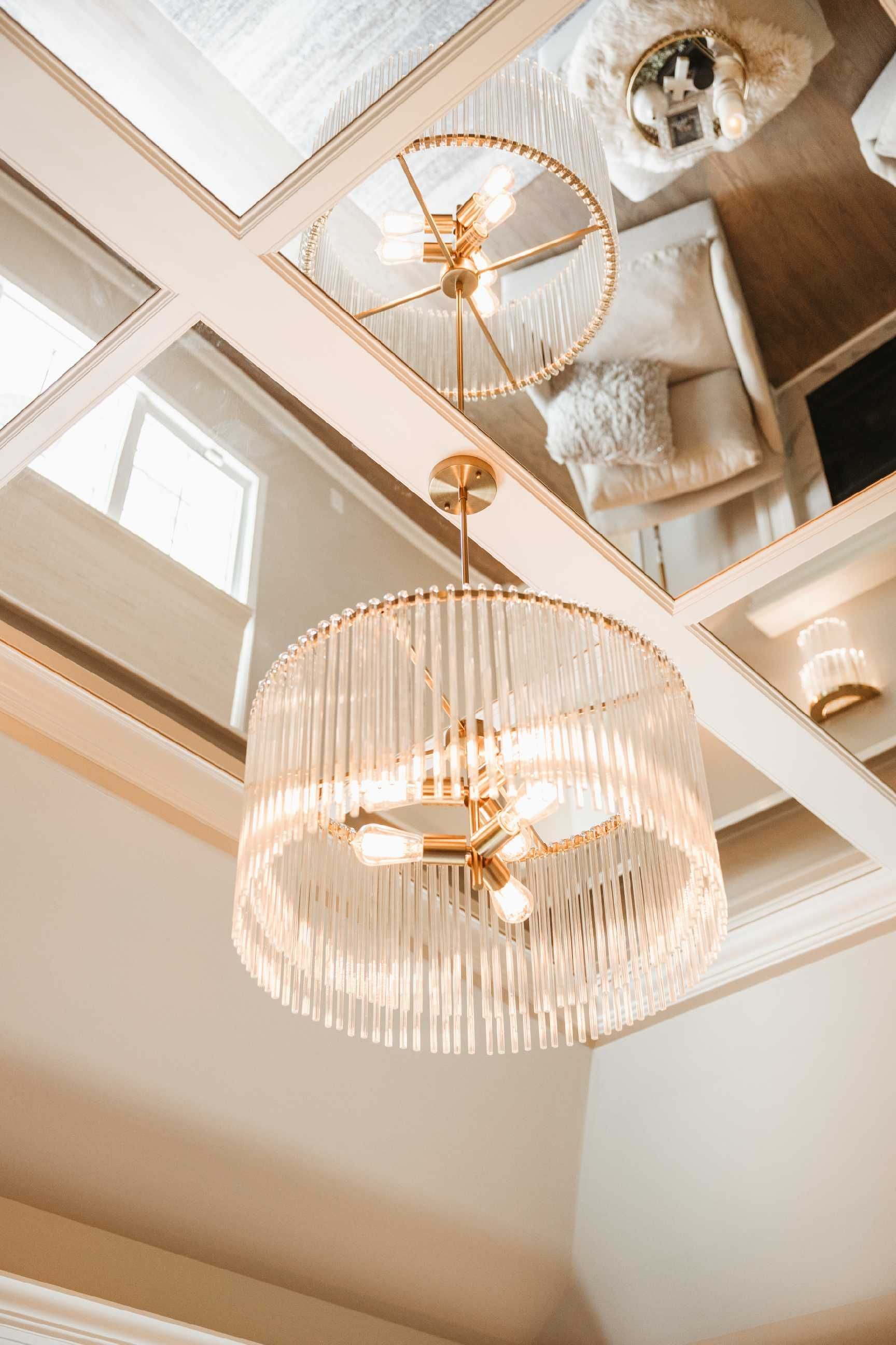 Gold and white chandelier hanging from a ceiling