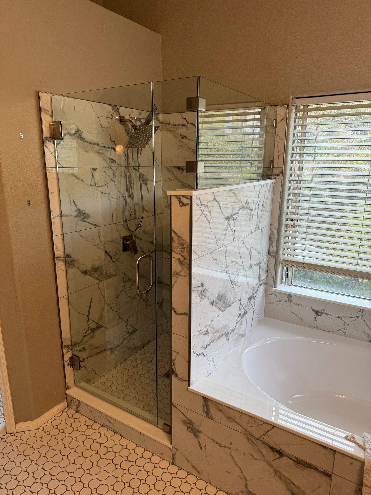 A bathroom with a tub , shower , and window.