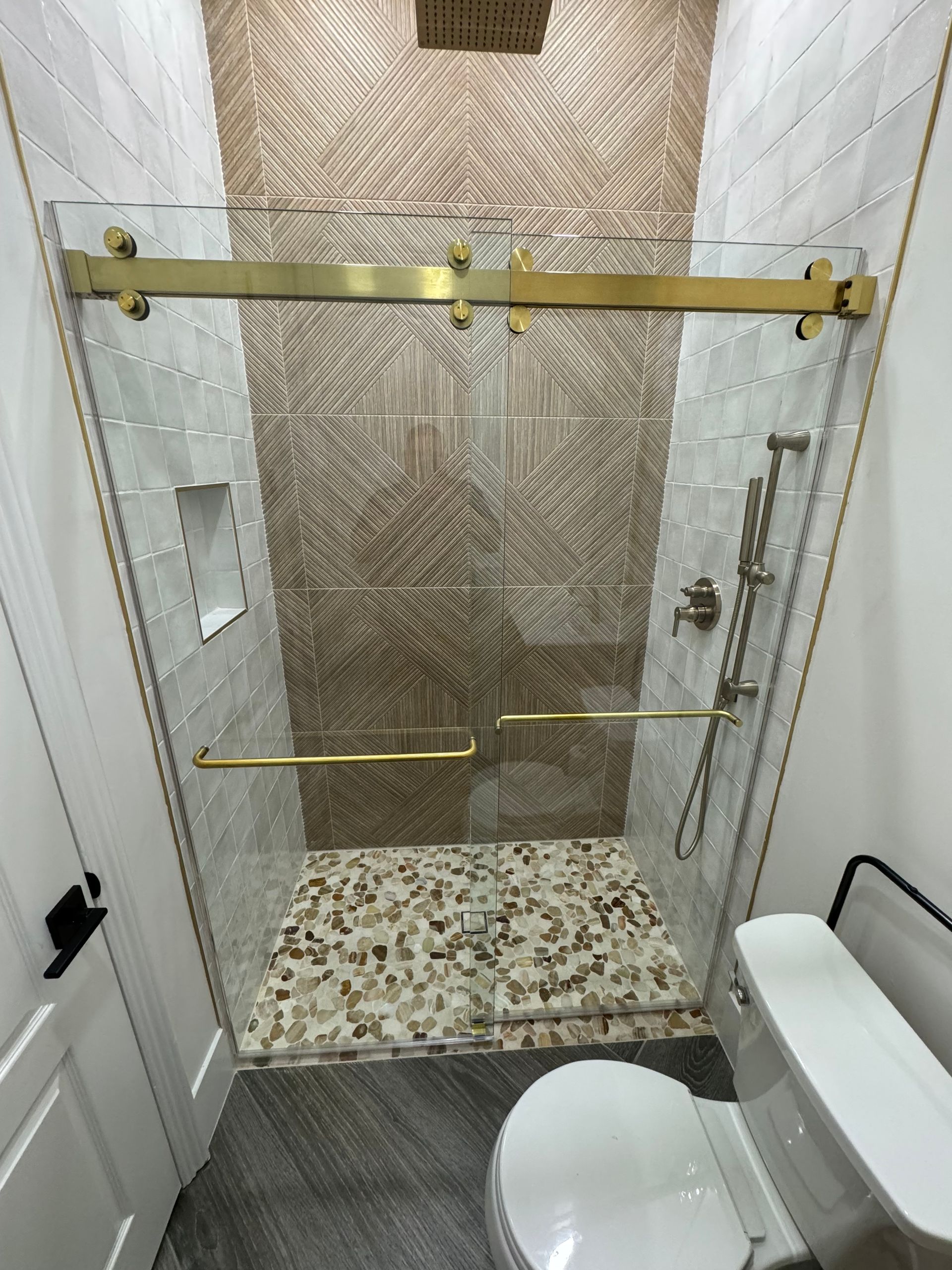 A bathroom with a walk in shower and a toilet.