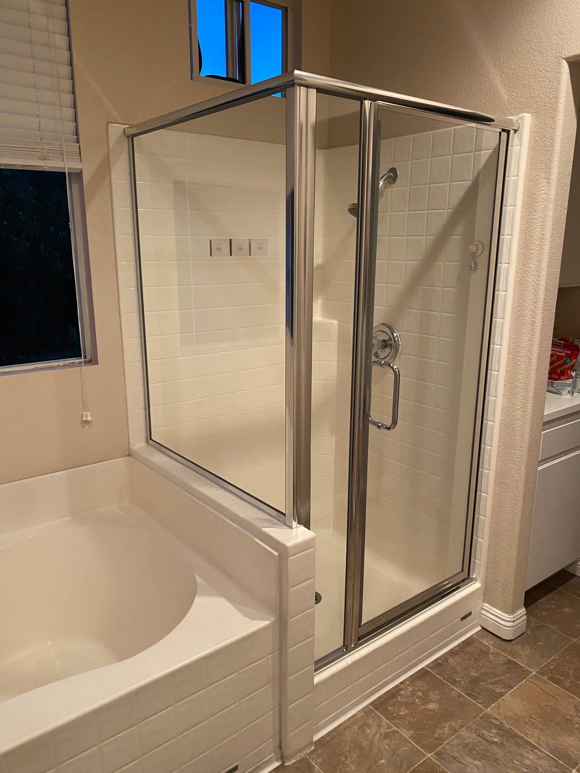 A bathroom with a bathtub and a shower stall.