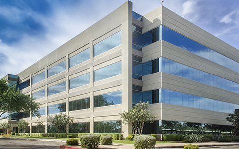 an beige office building with glass windows