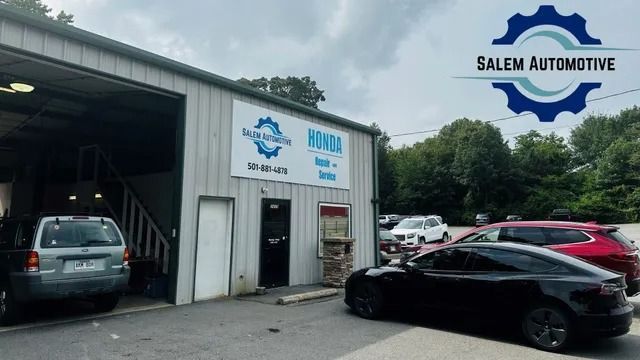Salem Automotive garage with cars parked outside. Signage, and a Tesla in foreground.
