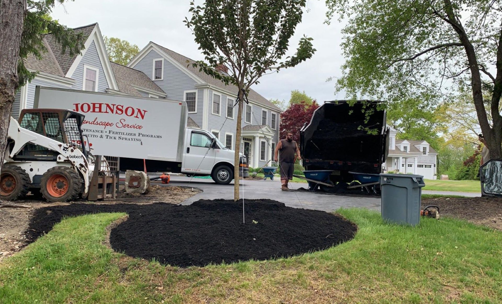 A johnson truck is parked in front of a house.