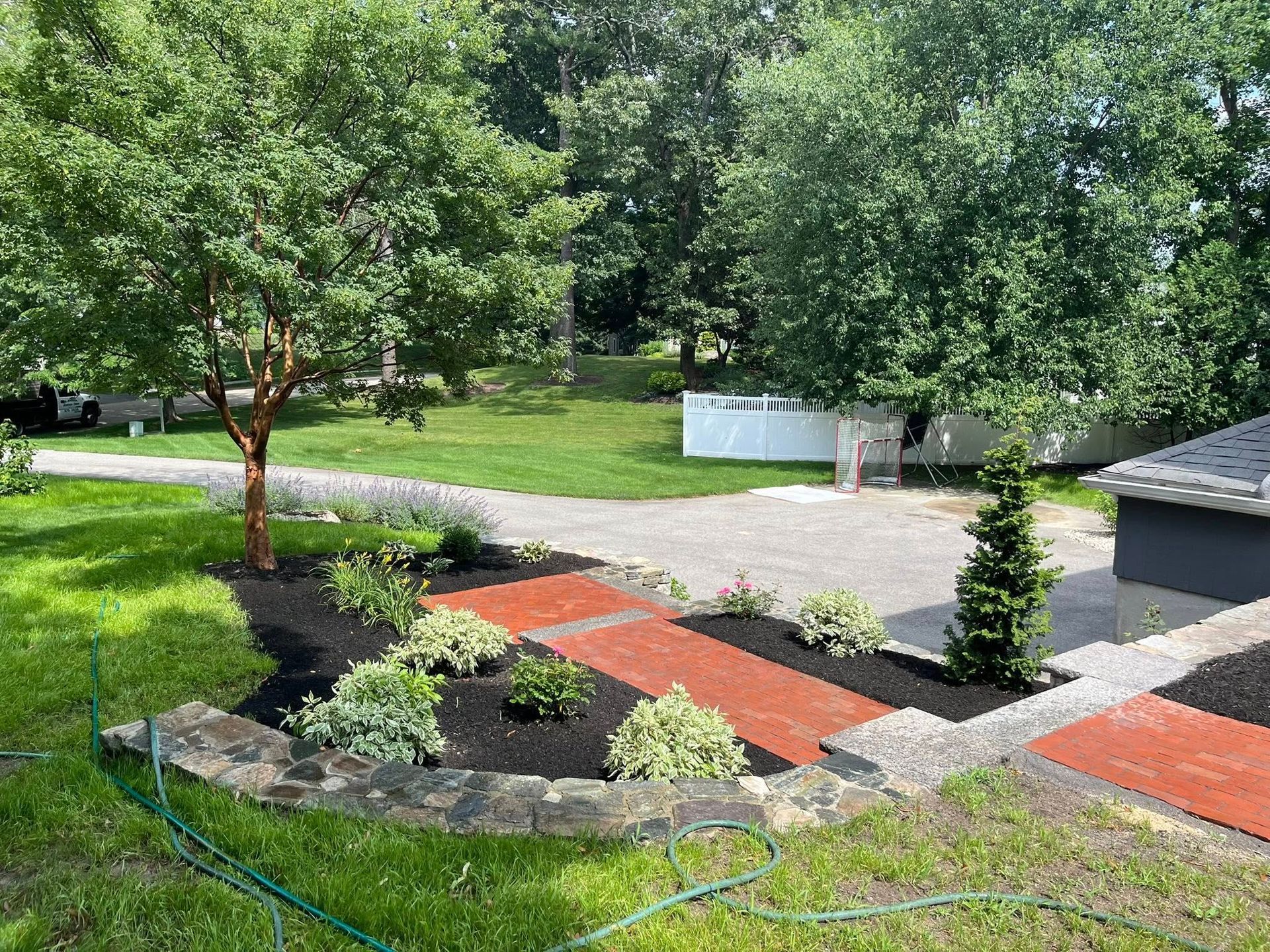 There is a hose in the middle of the yard.