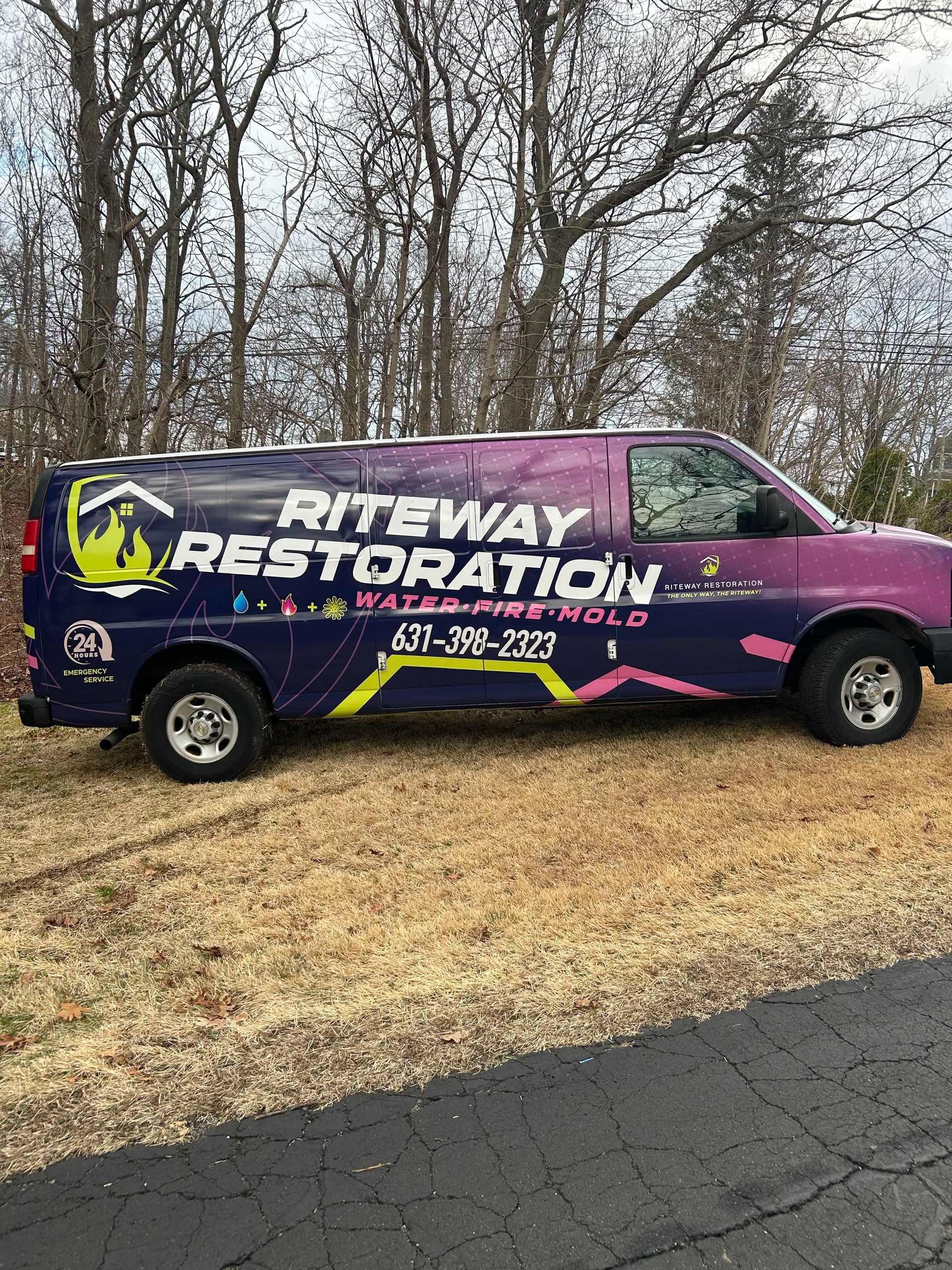 A purple and black Riteway Restoration work van parked on grass, with company name and contact info displayed in white.