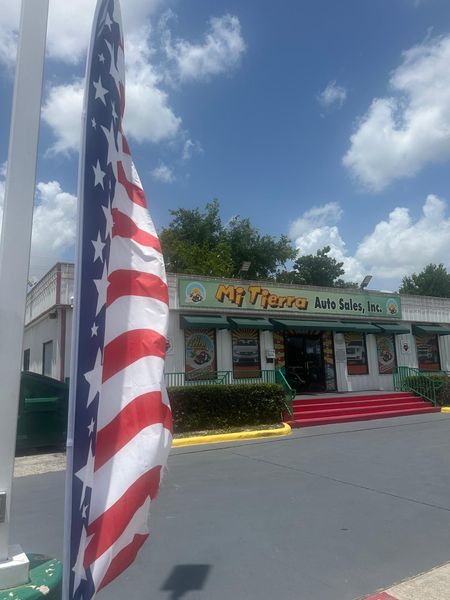 An american flag is flying in front of a restaurant.