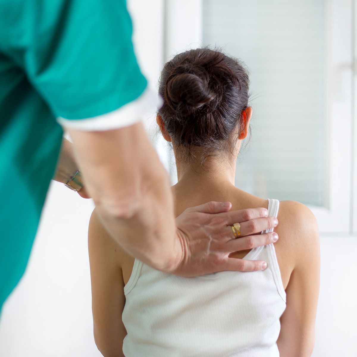 A man is putting his hand on a woman's back.