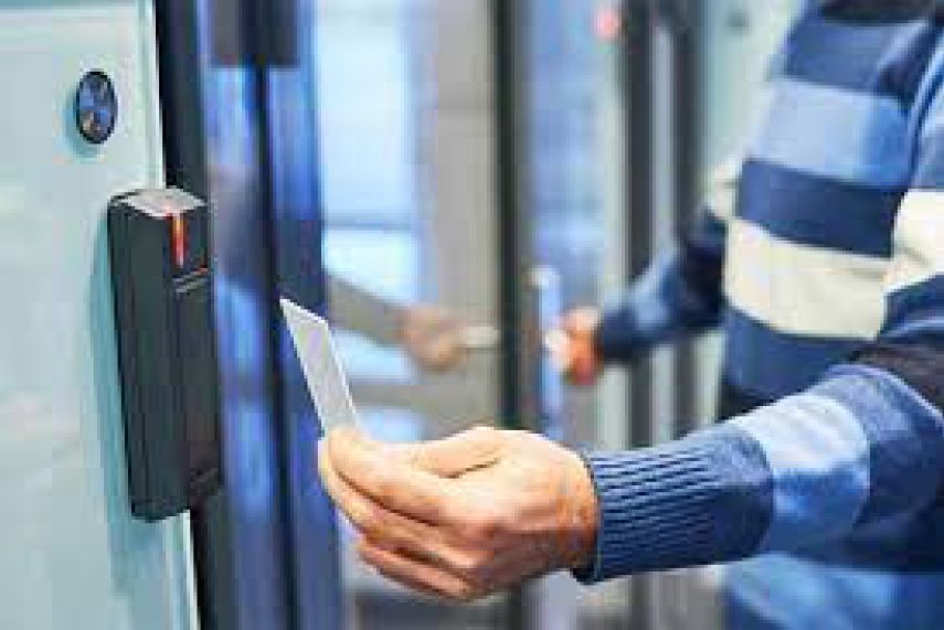 A man is using a smart card to open a door.