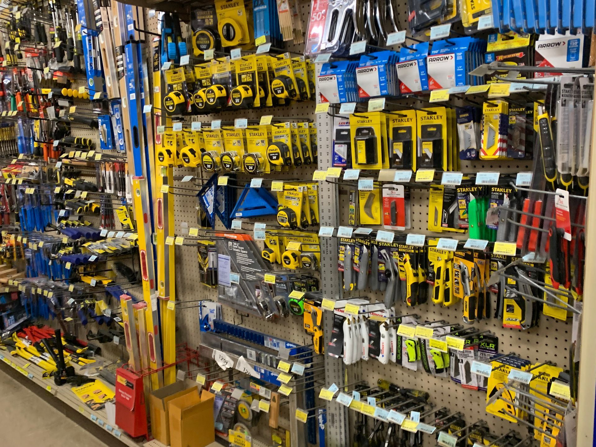 A shelf in a hardware store filled with lots of tools