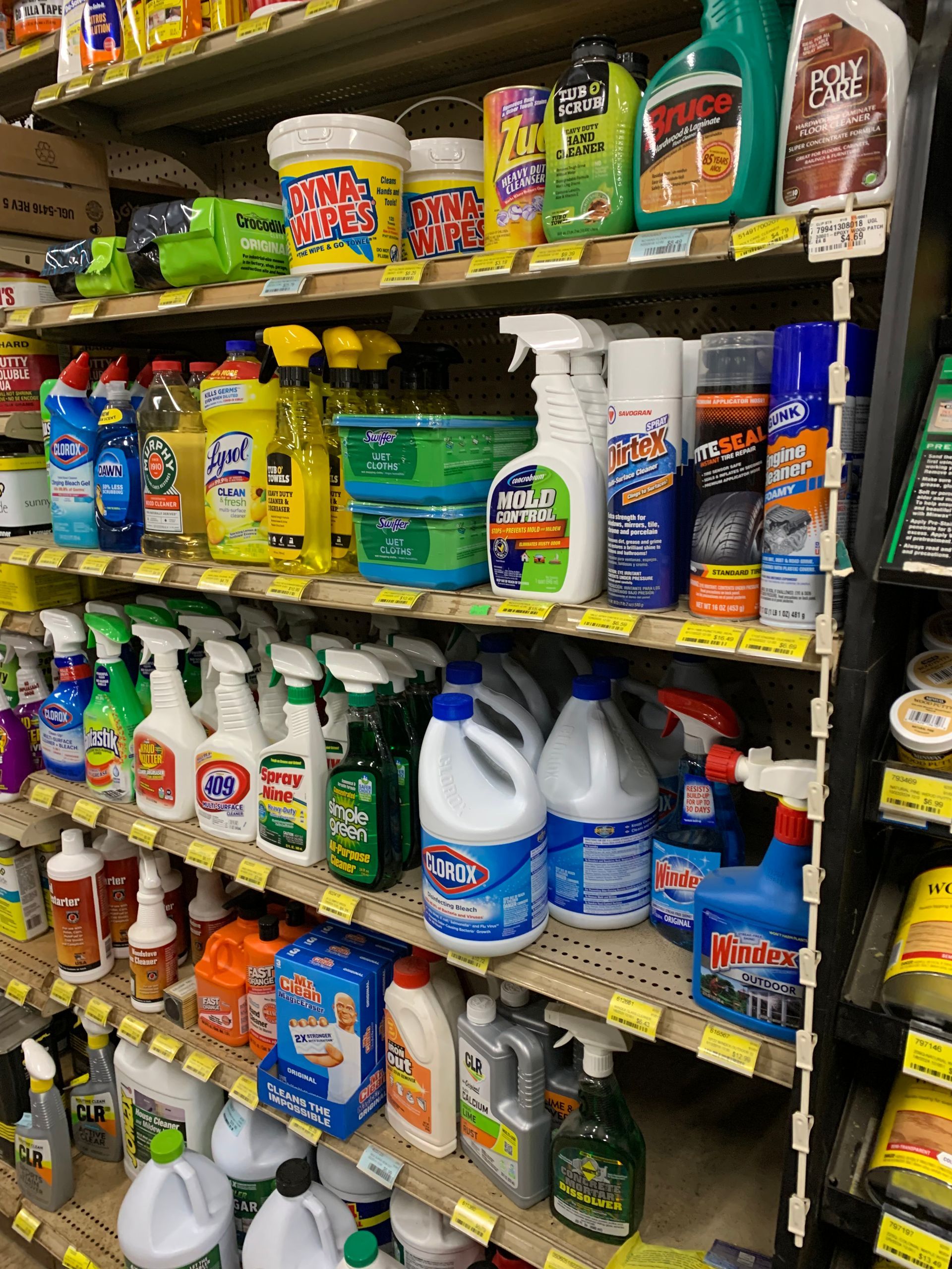 A grocery store shelf filled with lots of cleaning products