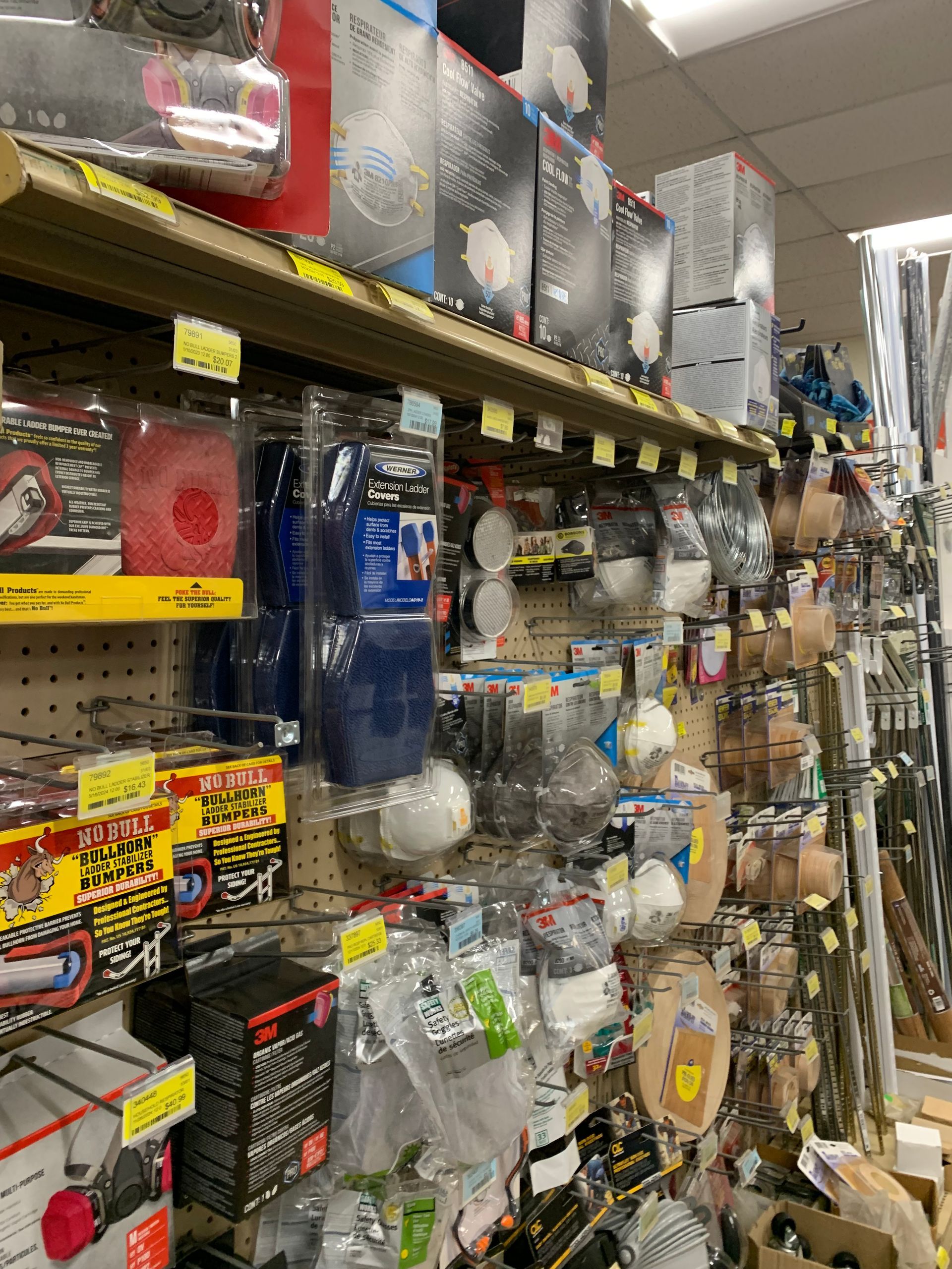 A store aisle filled with lots of items including a vacuum cleaner