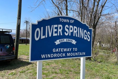 Blue Oliver Springs town sign, white lettering, 