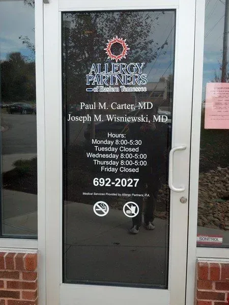 Door of Allergy Partners, displaying names, hours, and phone number.