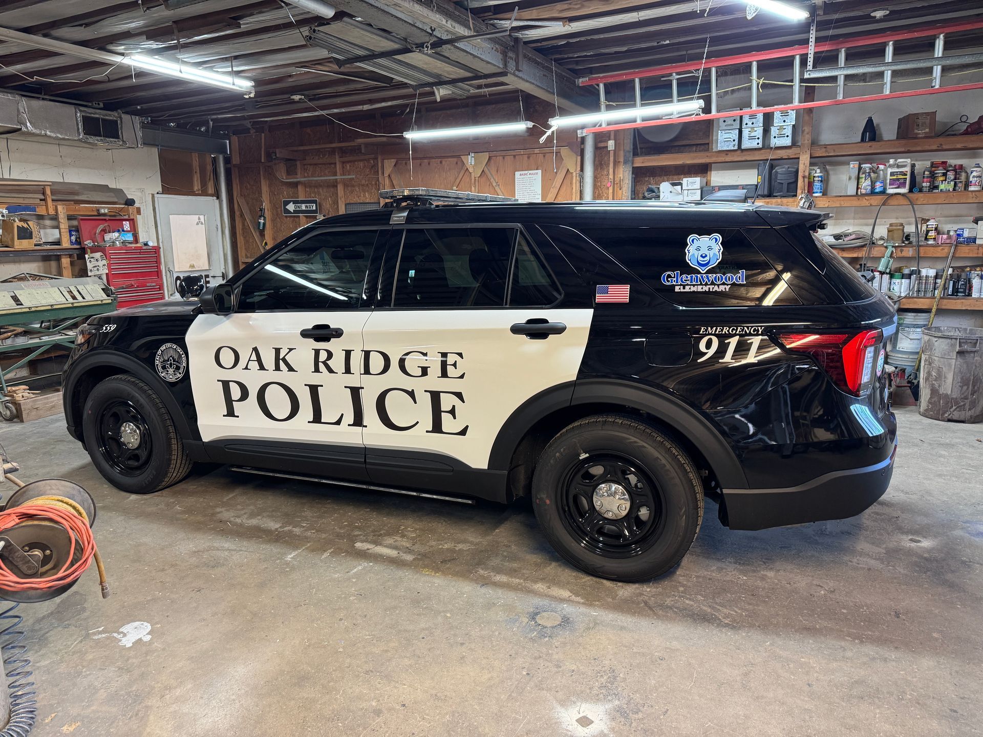 Black and white Oak Ridge Police SUV parked inside a garage.