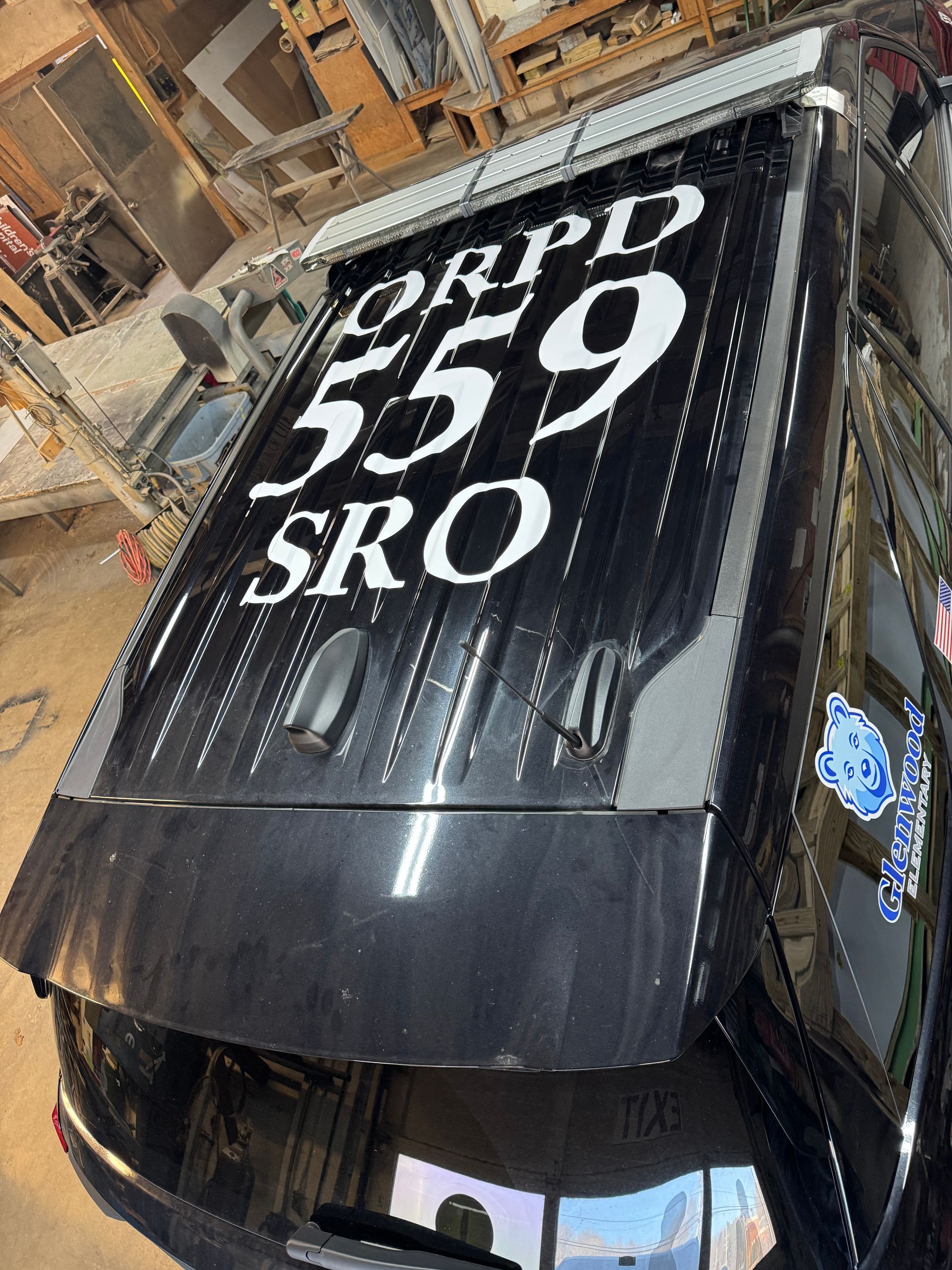Black police SUV roof with white lettering: 