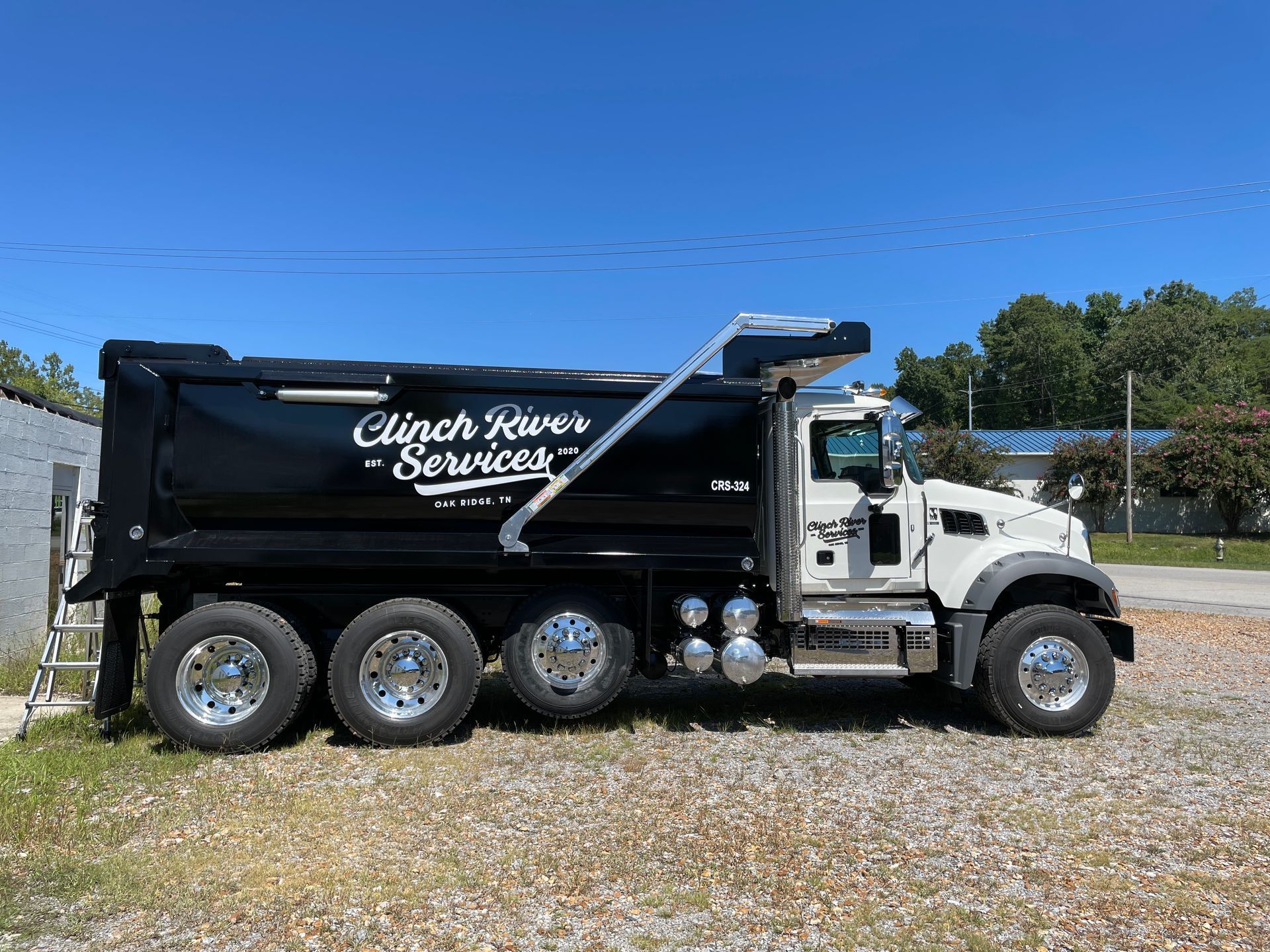 Black dump truck with the words 